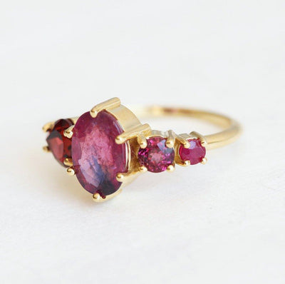 Oval-shaped sapphire cluster ring with ruby, garnet and diamond stones