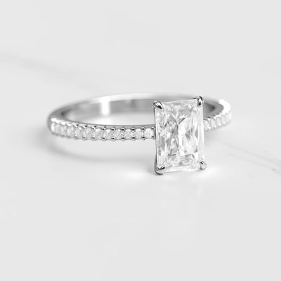 Radiant half pave tapered moissanite eternity ring