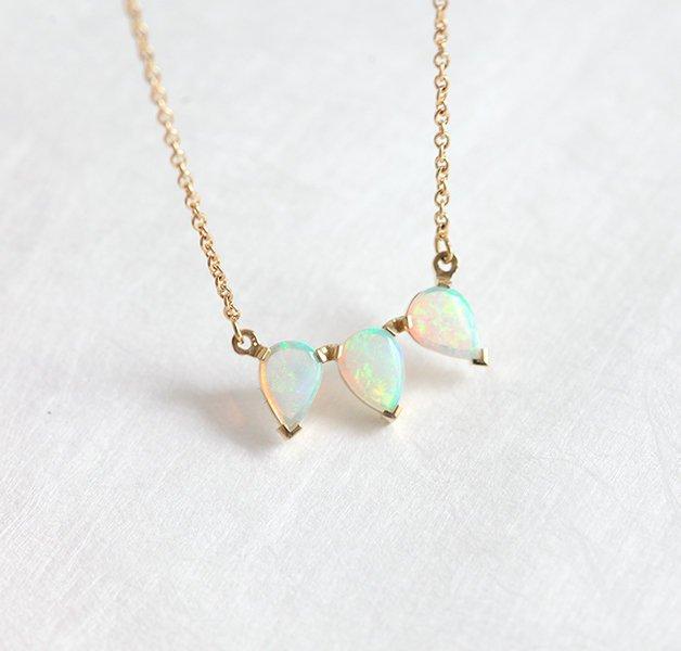 Gold chain with three white pear-shaped australian opal stones