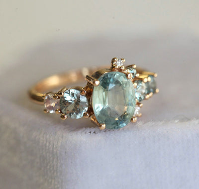 Oval light green sapphire cluster ring with moonstone and diamond gemstones