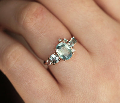 Oval light green sapphire cluster ring with moonstone and diamond gemstones