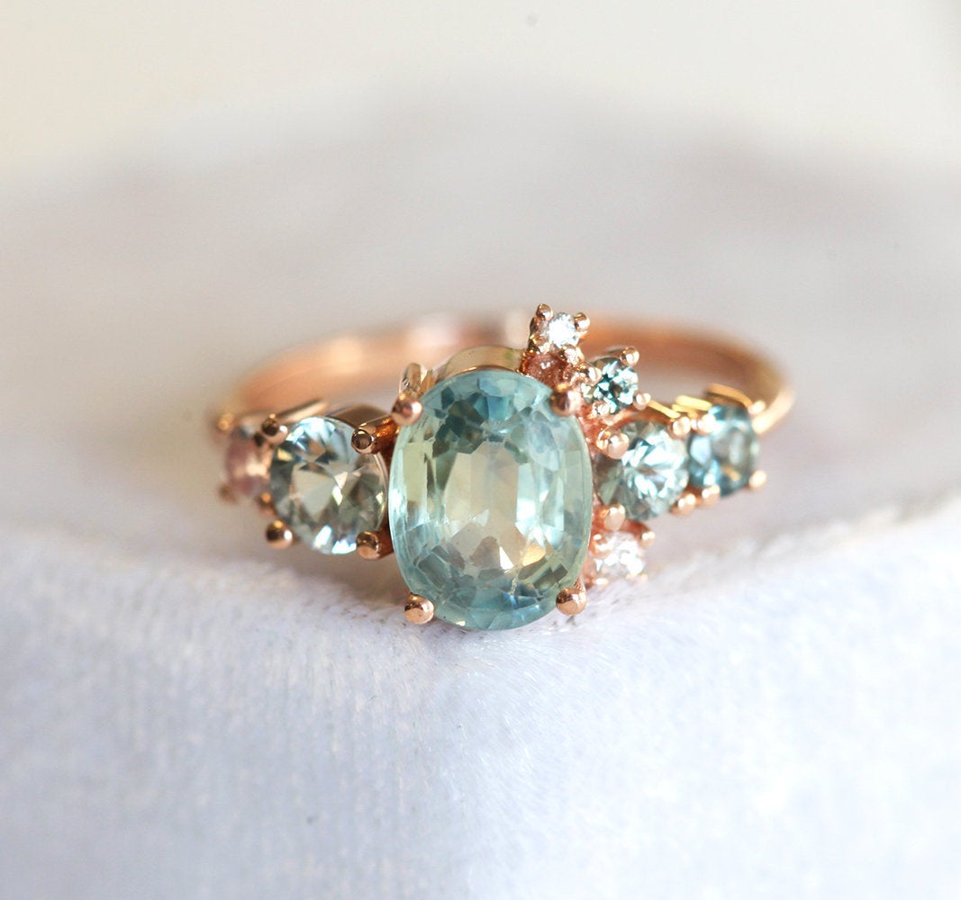 Oval light green sapphire cluster ring with moonstone and diamond gemstones