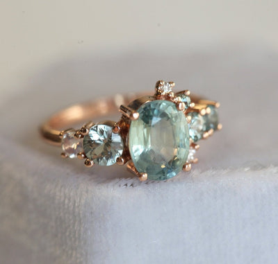 Oval light green sapphire cluster ring with moonstone and diamond gemstones