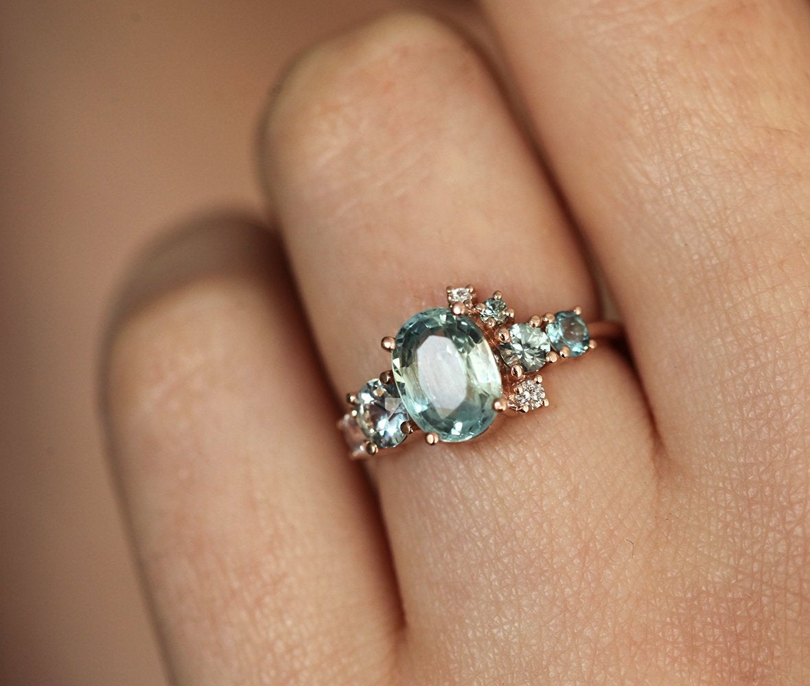 Oval light green sapphire cluster ring with moonstone and diamond gemstones