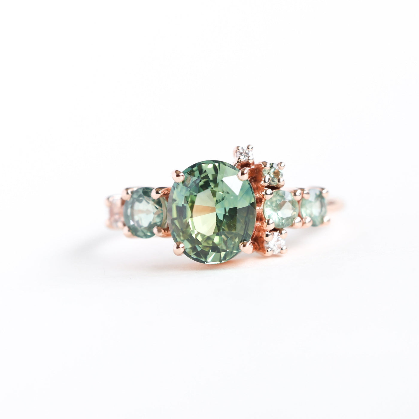Oval light green sapphire cluster ring with moonstone and diamond gemstones