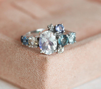 Oval Moonstone Cluster Ring with Side White Diamons, Tanzanite, Sapphire and Aquamarine Gemstones