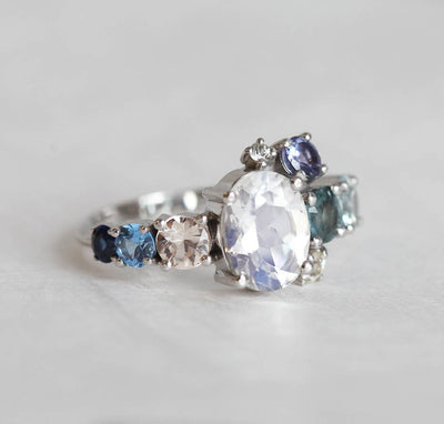 Oval Moonstone Cluster Ring with Side White Diamons, Tanzanite, Sapphire and Aquamarine Gemstones