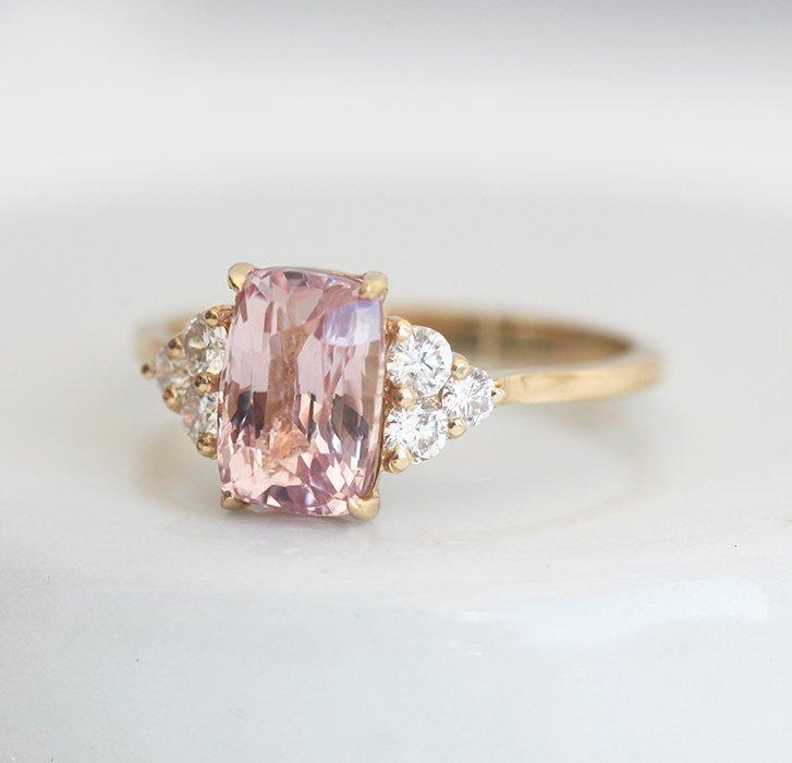 Cushion-cut peach pink champagne sapphire cluster ring with white diamonds
