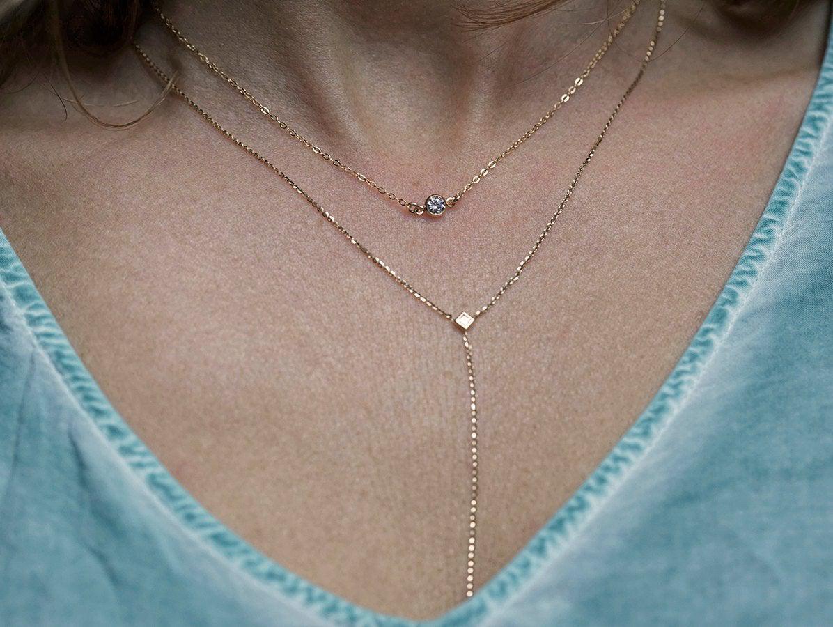 Gold chain necklace with round cubic zirconia and matching gold drop necklace