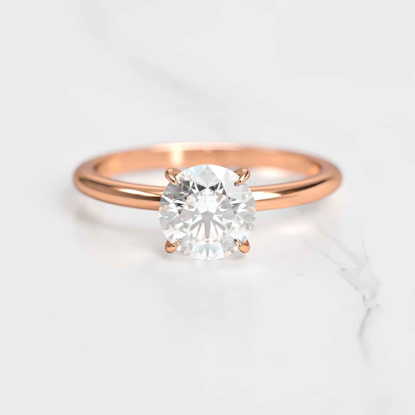 Round tapered solitaire diamond ring