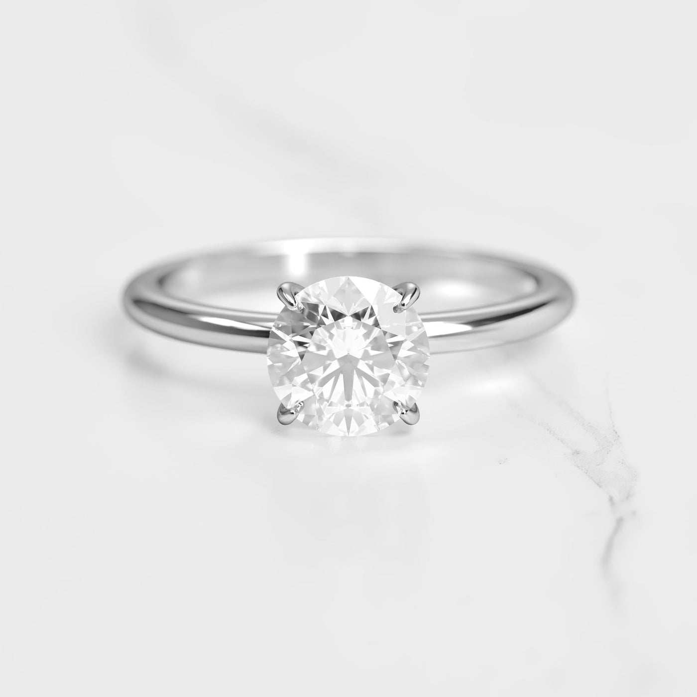 Round tapered solitaire diamond ring