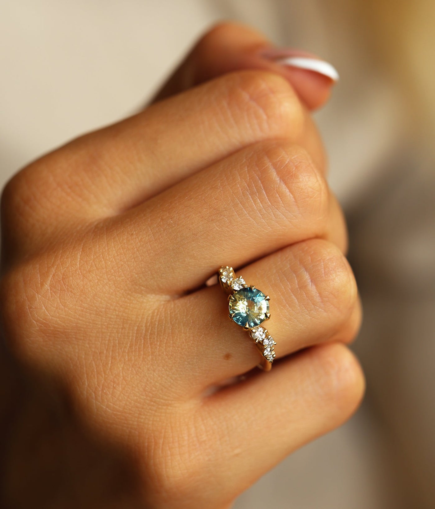 Round bicolor sapphire and diamond cluster ring