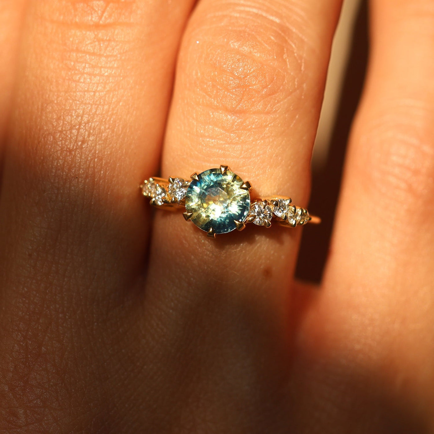 Round bicolor sapphire and diamond cluster ring