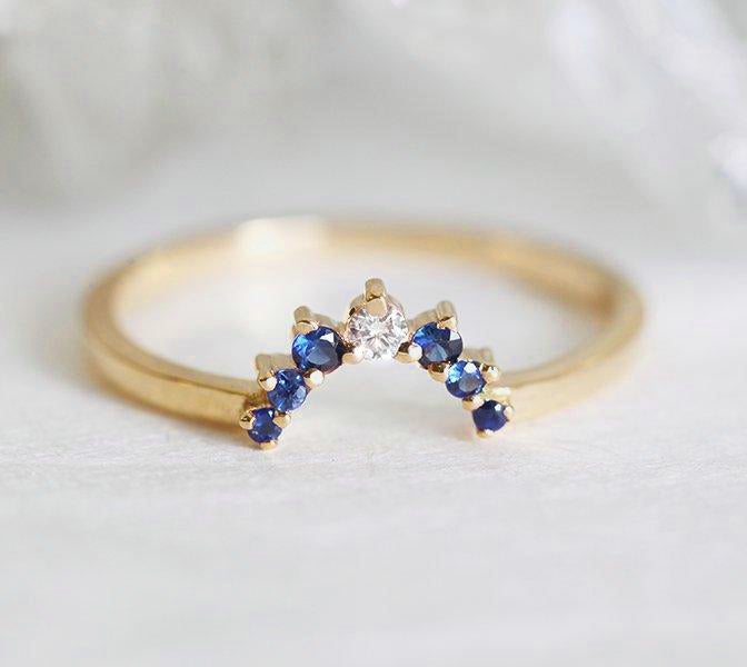 Round white diamond cluster ring with sapphire gemstones