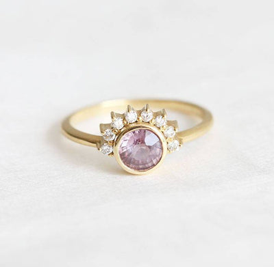 Round pink sapphire ring with diamond halo