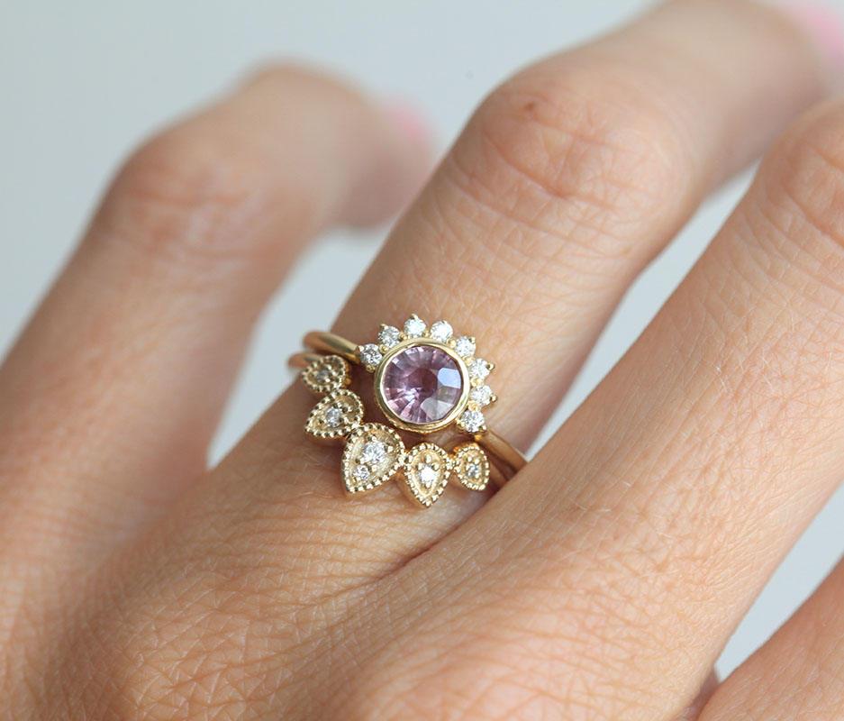 Round pink sapphire ring with diamond halo