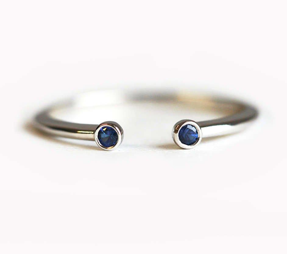 Round blue sapphire horseshoe wedding ring
