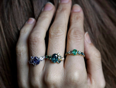 Oval green tourmaline cluster ring with round sapphires