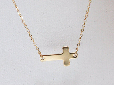 Gold sideways cross necklace