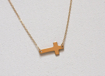 Gold sideways cross necklace