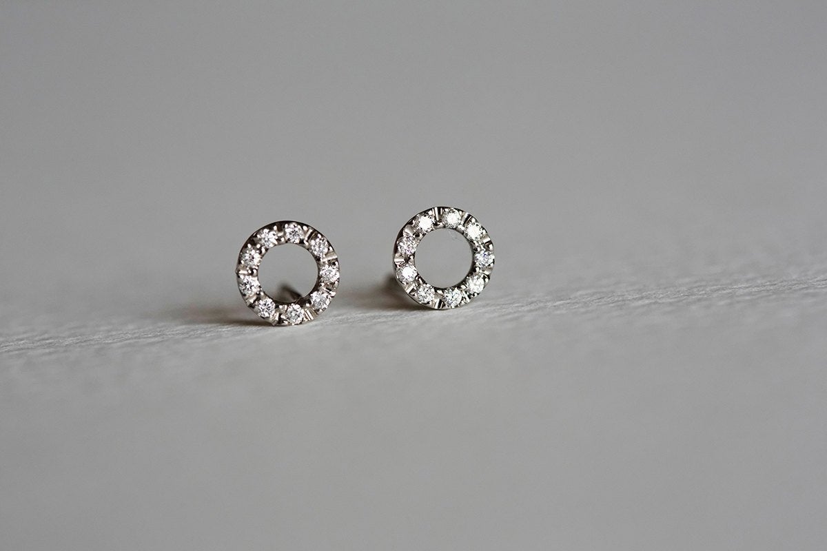 Gold stud earrings with round diamond halo