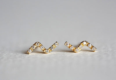 Z-shaped gold stud earrings with round white diamonds