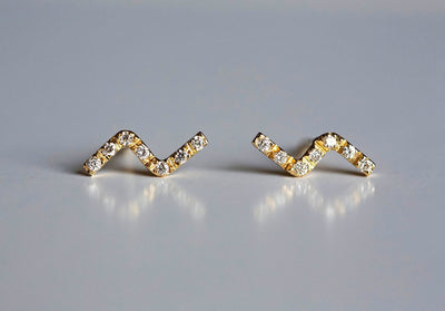 Z-shaped gold stud earrings with round white diamonds