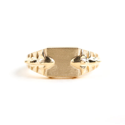 Close-up of a snake gold signet ring highlighting its intricate details.