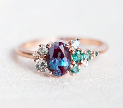 Purple Oval Alexandrite Ring with Side White Diamonds, Sapphire and Emerald Stones