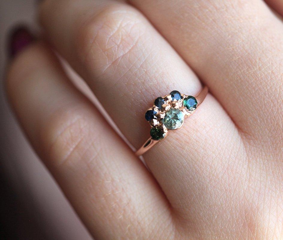 Round teal sapphire ring with green and blue accent sapphires