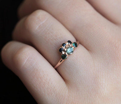 Round teal sapphire ring with green and blue accent sapphires