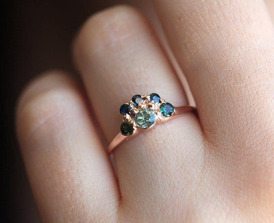 Round teal sapphire ring with green and blue accent sapphires