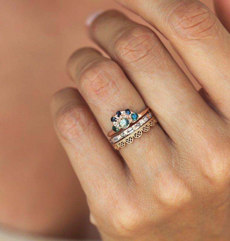 Round teal sapphire ring with green and blue accent sapphires stacked