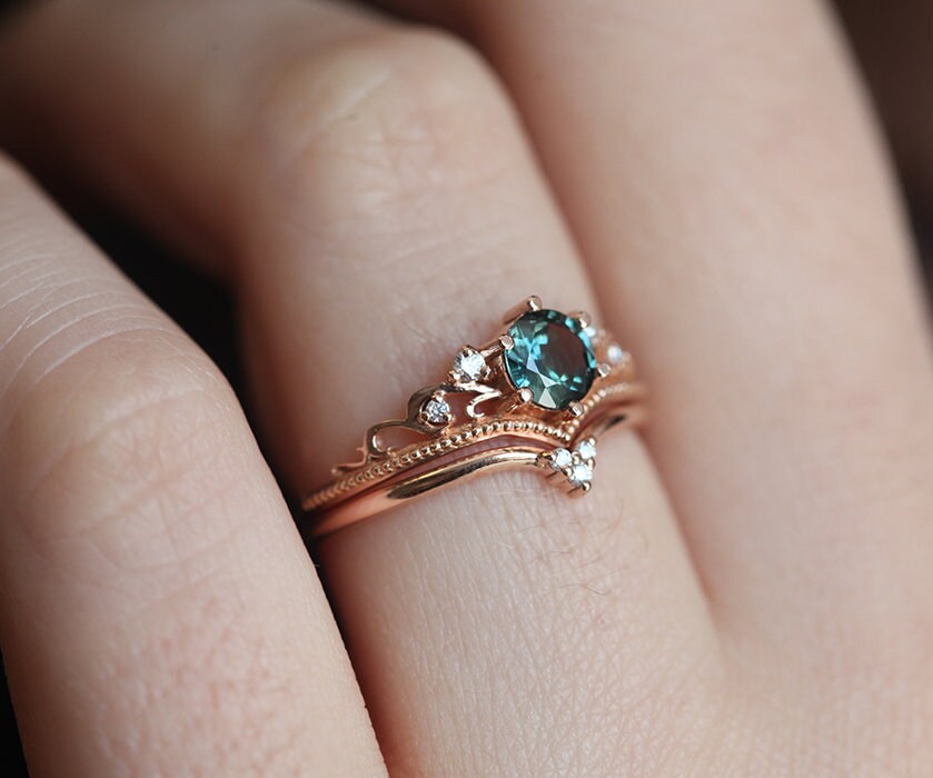 Nested round teal sapphire engagement ring set with white diamonds