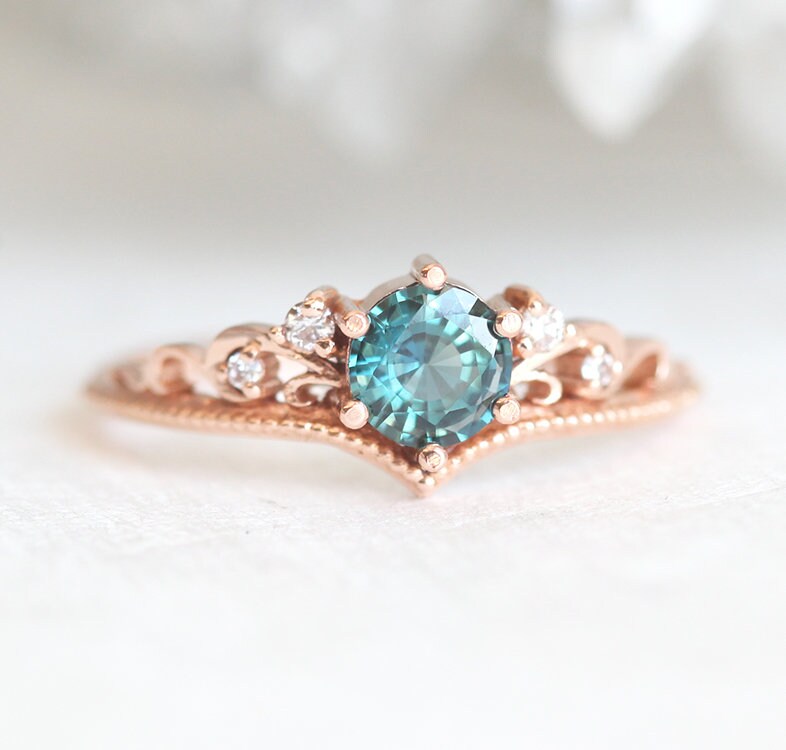 Nested round teal sapphire engagement ring set with white diamonds