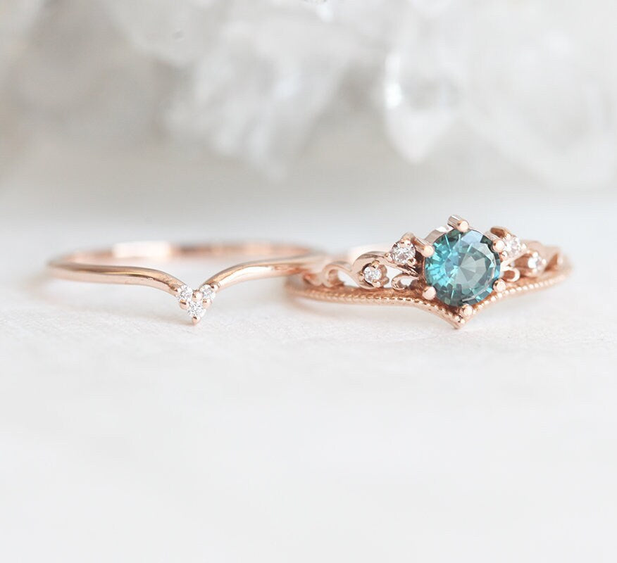 Nested round teal sapphire engagement ring set with white diamonds