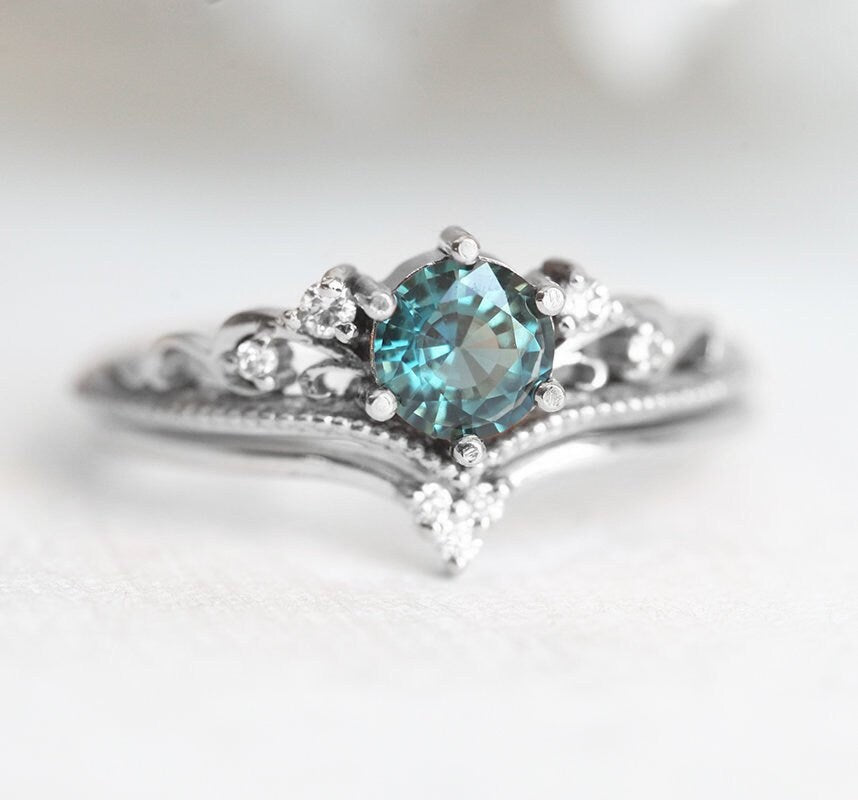 Nested round teal sapphire engagement ring set with white diamonds