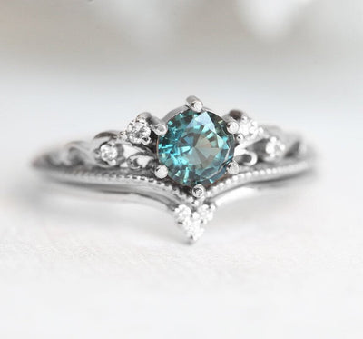 Nested round teal sapphire engagement ring set with white diamonds