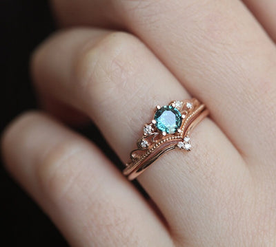 Nested round teal sapphire engagement ring set with white diamonds