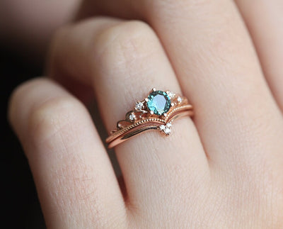 Nested round teal sapphire engagement ring set with white diamonds