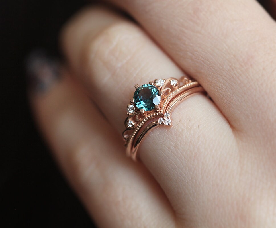 Nested round teal sapphire engagement ring set with white diamonds