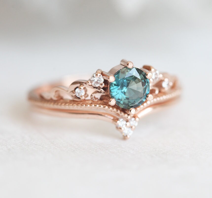 Nested round teal sapphire engagement ring set with white diamonds