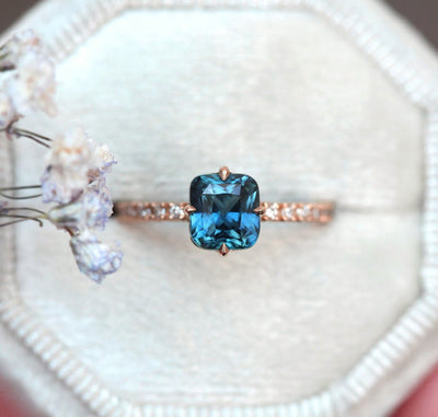 Cushion-cut blue sapphire eternity ring with white diamonds