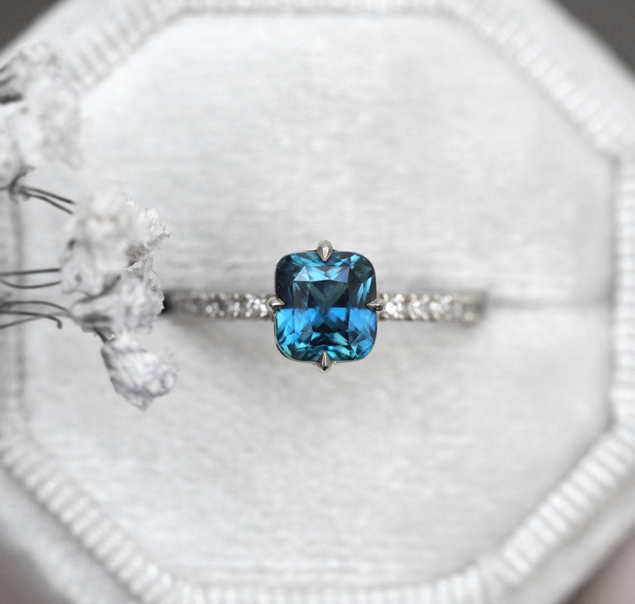 Cushion-cut blue sapphire eternity ring with white diamonds