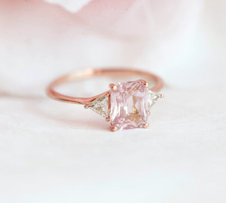 Radiant peach pink sapphire ring with white side diamonds