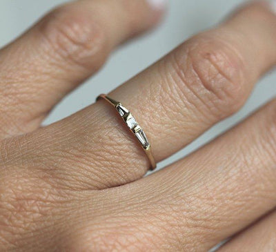 Thin square-shaped white diamond ring with baguette-cut side diamonds