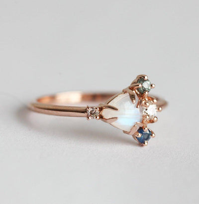 Trillion-cut white moonstone cluster ring with diamond and sapphire gemstones