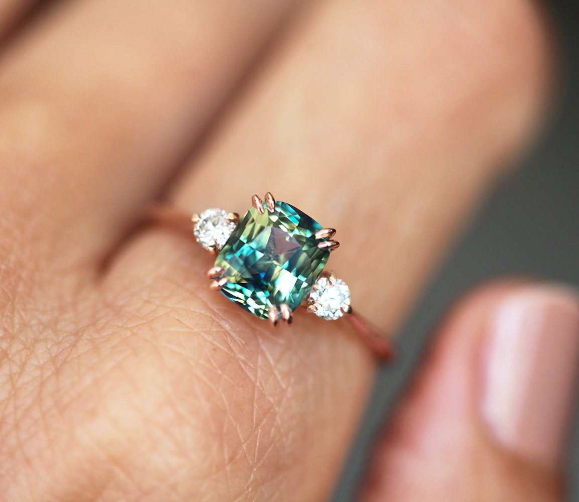 Cushion-cut blue sapphire ring with white diamonds