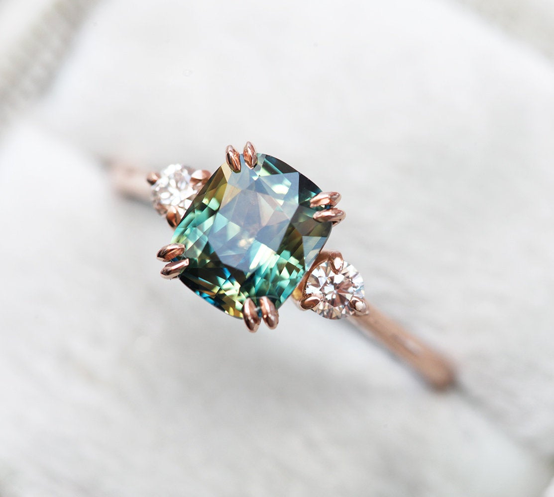 Cushion-cut blue sapphire ring with white diamonds