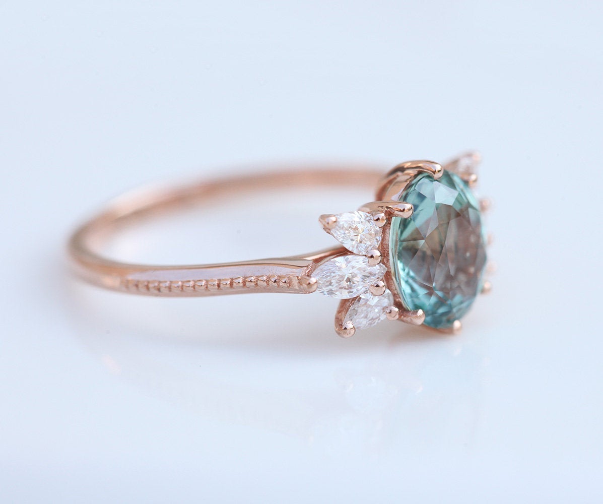 Oval-shaped mint sapphire ring with white diamonds